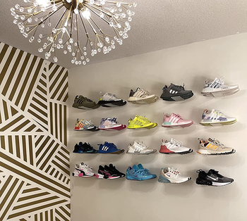 reviewer photo of wall of sneakers on floating shelves