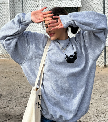 front of the gray pullover with a bunny on it