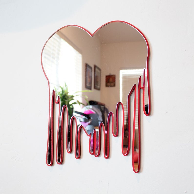 Dripping heart-shaped mirror with red rim