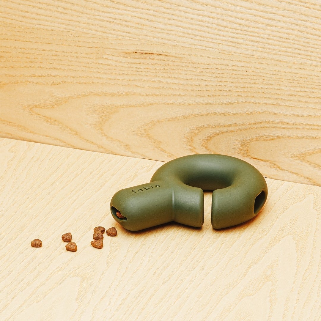 toy in hook shape with narrow hole for kibble and a shallow hole for soft food 