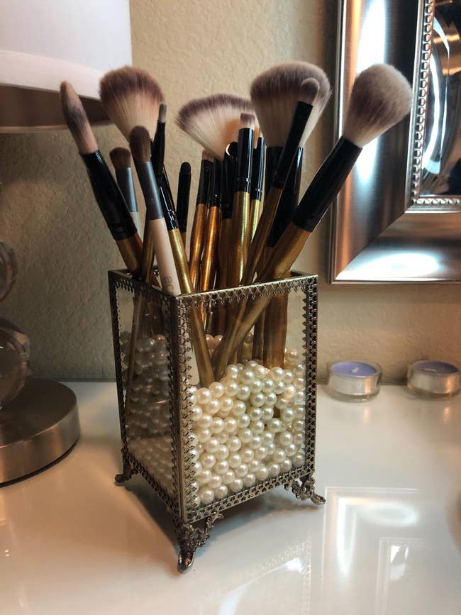 reviewer's holder filled with achromatic  pearl beads with constitution  brushes successful  it