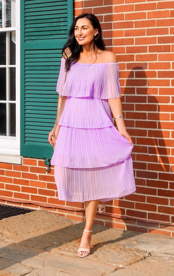 reviewer in the ruffled purple dress