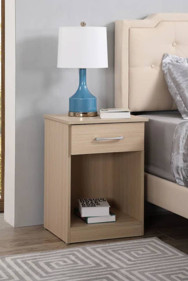 beige one-drawer nightstand, lifestyle image, next to bed