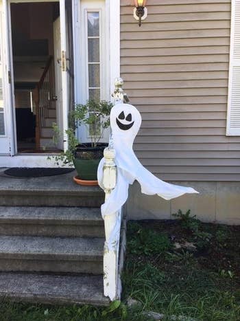 the ghost wrapped around a fence railing