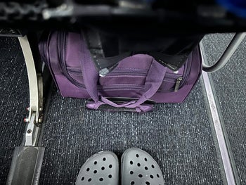another reviewer's purpe wheeled carry on under the seat ahead of them on a plane