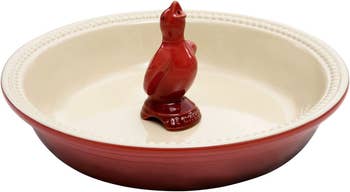A red pie bird in a matching dish