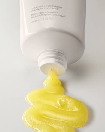 a tube of rhode pineapple refresh daily cleanser being squeezed