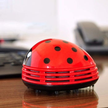 ladybug shaped desk vacuum sitting on a desk