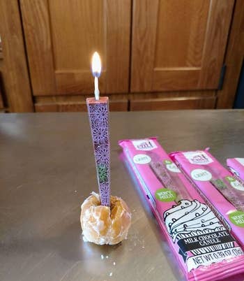 a lit candle in a donut hole