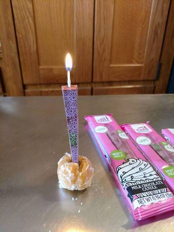 a lit candle in a donut hole