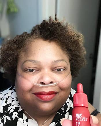 reviewer wearing the lipstick and holding the matching tube