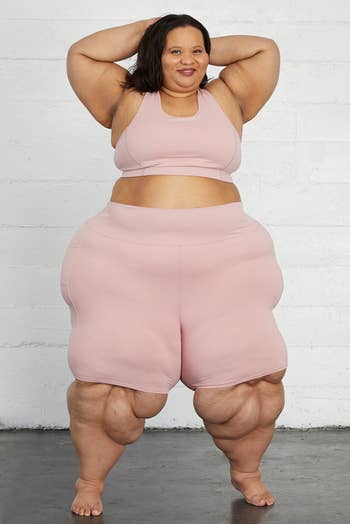 Model in a pair of blush pink knee length compressive bike shorts 