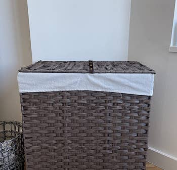 a reviewer photo of the closed clothes hamper in brown 