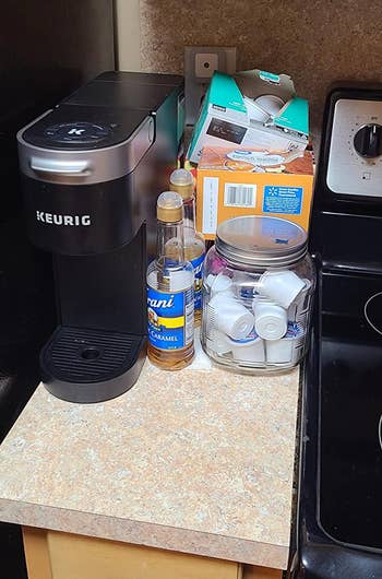 a reviewer's before showing their counter cluttered with K-Cup boxes and syrup bottles