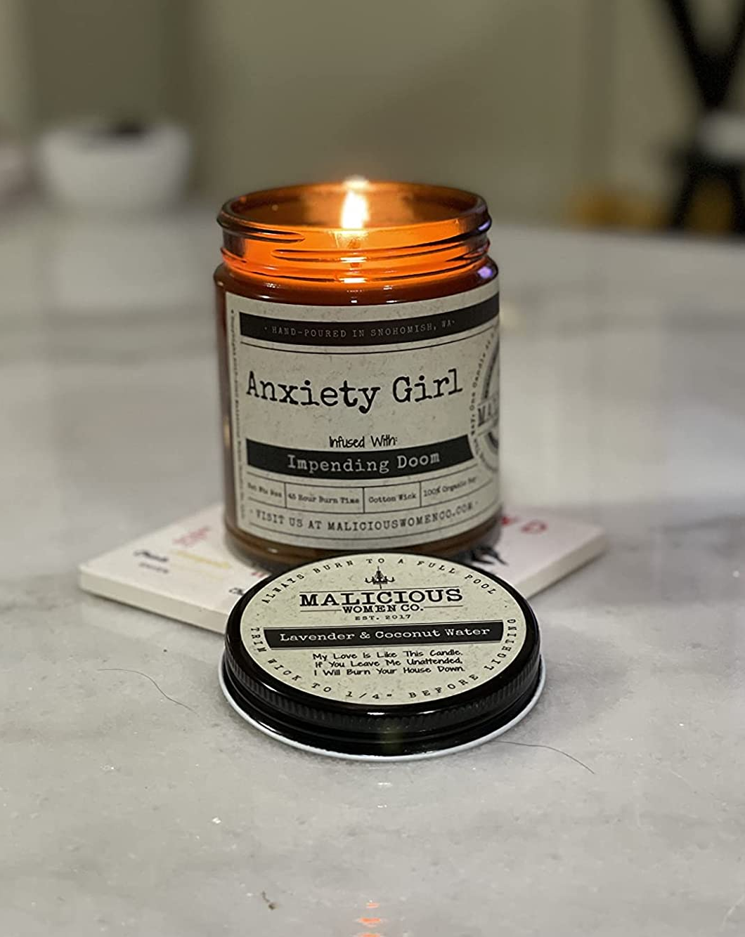 Reviewer photo of the candle with a label that says