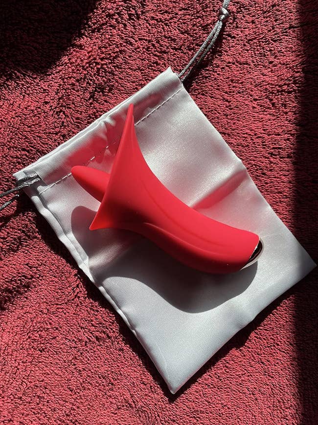 reviewer's red tongue vibrator on silver bag