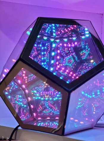 A reviewer's kaleidoscope-like lamp with intricate LED light patterns