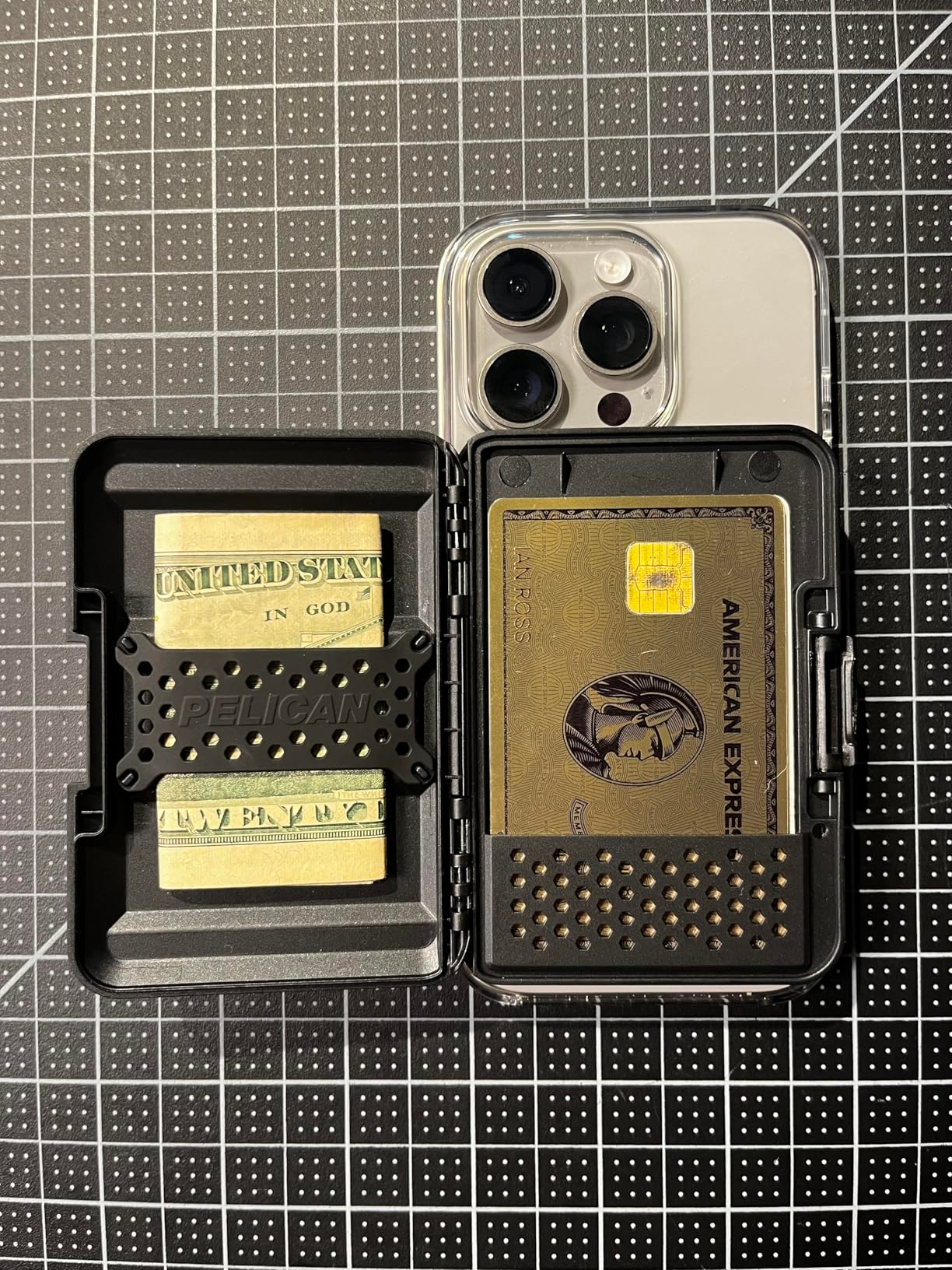 A smartphone lawsuit  displaying a holder with currency  and an American Express card, acceptable   connected  a grid-patterned surface