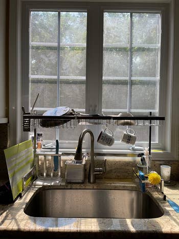 reviewer's silver rack over the sink holding dishes