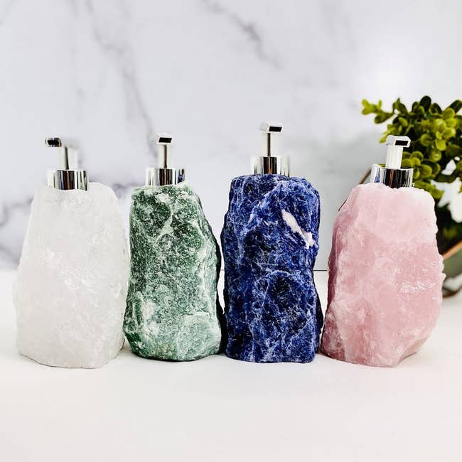 white, green, blue, and pink stone pump bottles