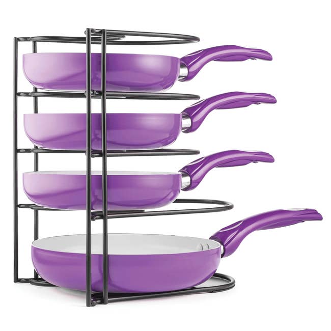 A set of purple pans in a black pan holder