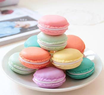 A stack of colorful macaron-shaped storage boxes on a plate