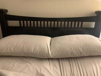 a reviewer's two pillows on their bed