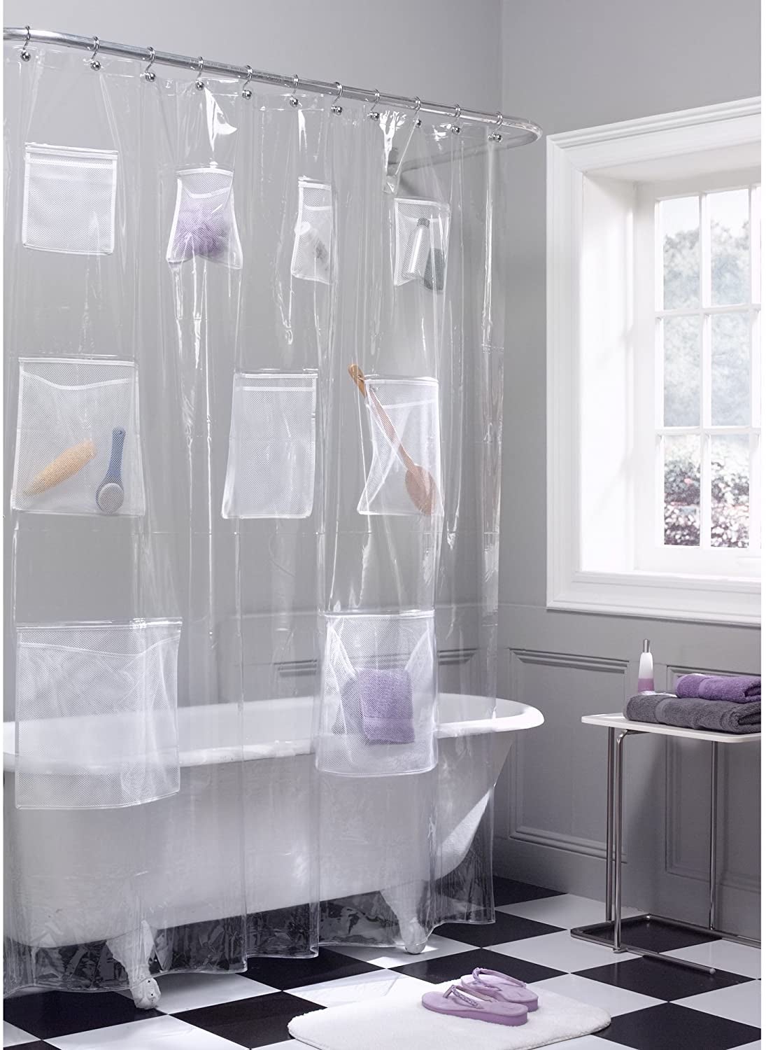 transparent shower curtain with bunch of pockets holding bottles and body brushes