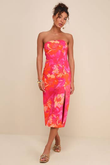 model successful  a floral strapless formal  with a slit, accessorized with hoop earrings and bracelets, suitable for a stylish buying  outing