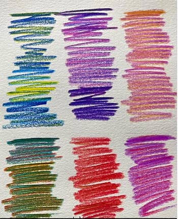 Close-up of a insubstantial  with scribbled crayon swatches successful  assorted  colors, showcasing antithetic  shades for examination  successful  a buying  context