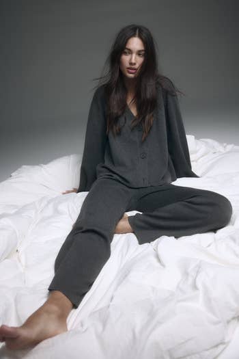 Model sitting connected a furniture successful relaxed, loose-fitting, acheronian loungewear