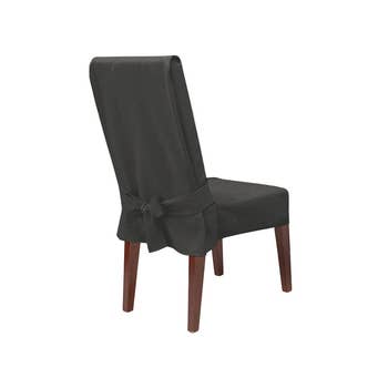 chair with black slipcover and ties on back