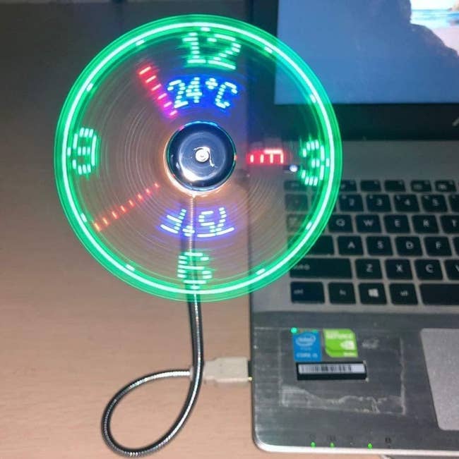 USB fan with LED lights displaying temperature and time, plugged into a laptop