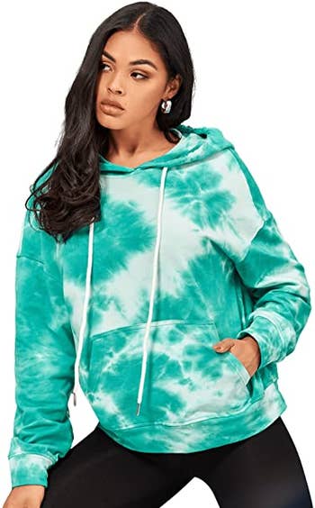 a model in a pullover hoodie in green and white tie dye