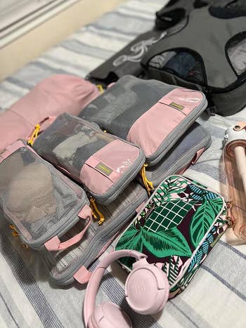 reviewer phot of the pink packing cubes with clothes in them
