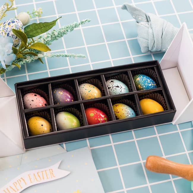 a box of beautifully decorated chocolate eggs