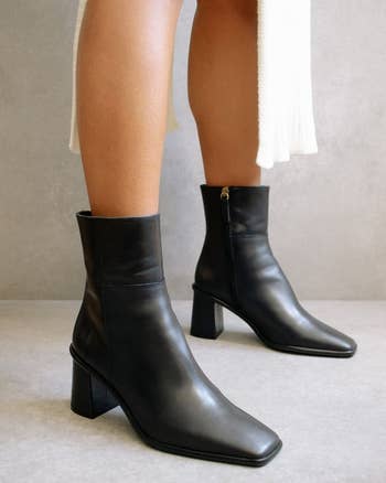 side view of model in the boots showing the heel and zipper