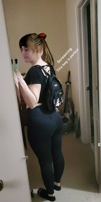 reviewer mirror selfie wearing mini backpack, caption 