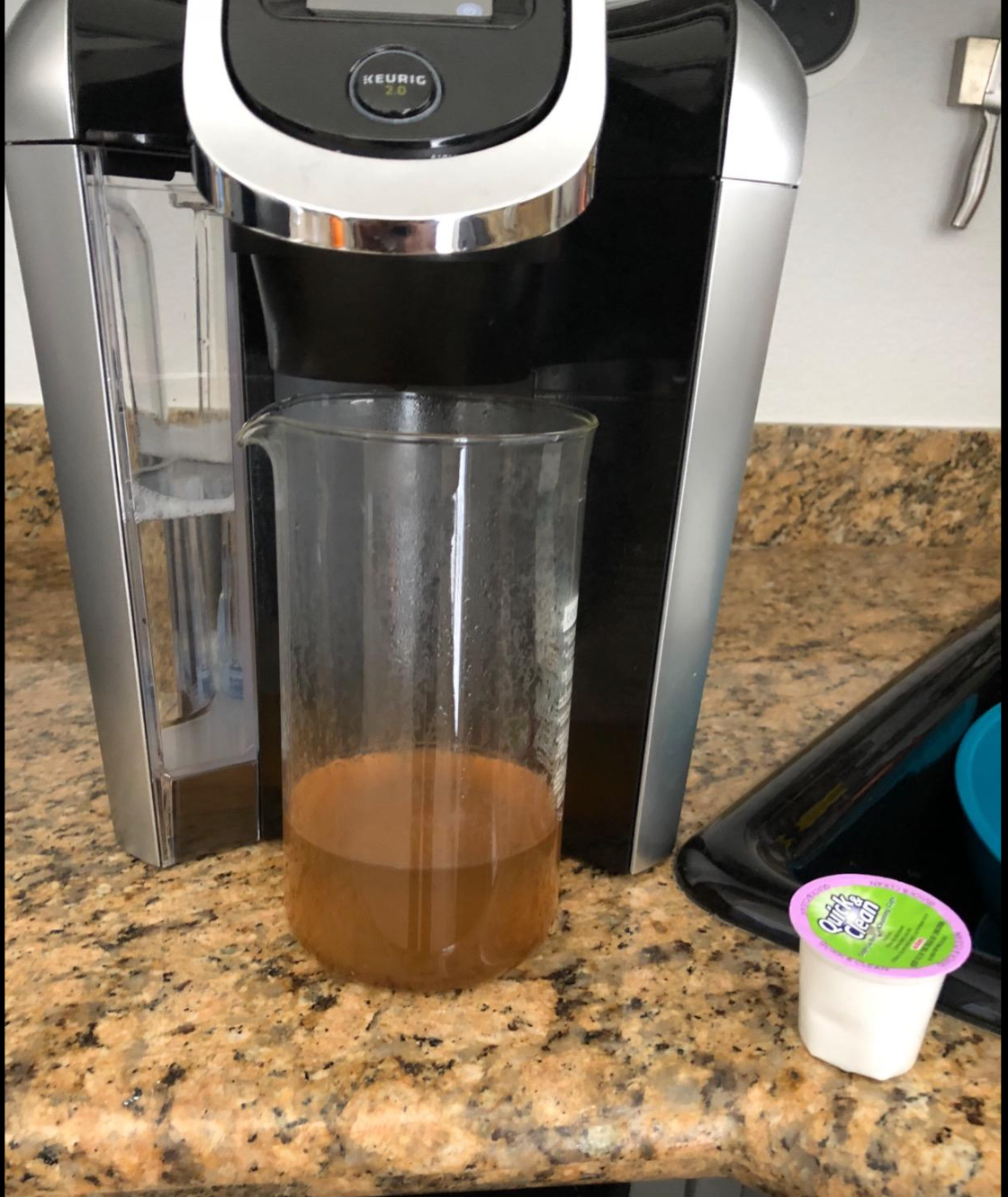 Reviewer image of dirty water from Keurig cleaned out from the pod 