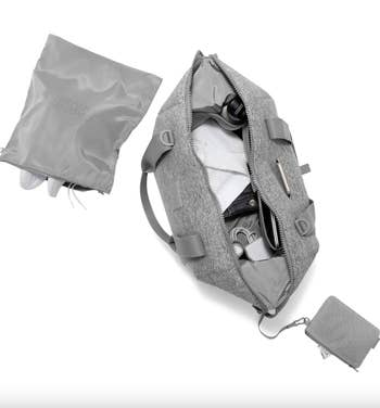 Gray duffle bag open to reveal compartments and parts