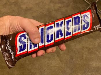 a reviewer holding the giant snickers