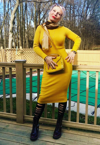 another reviewer wearing it in yellow with black leggings and boots