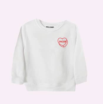 a white toddler sweatshirt with a custom heart on it