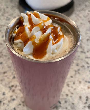 reviewer photo of a hot drink topped with whipped cream and the pumpkin pie sauce