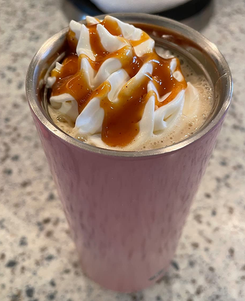 reviewer photo of a hot drink topped with whipped cream and the pumpkin pie sauce