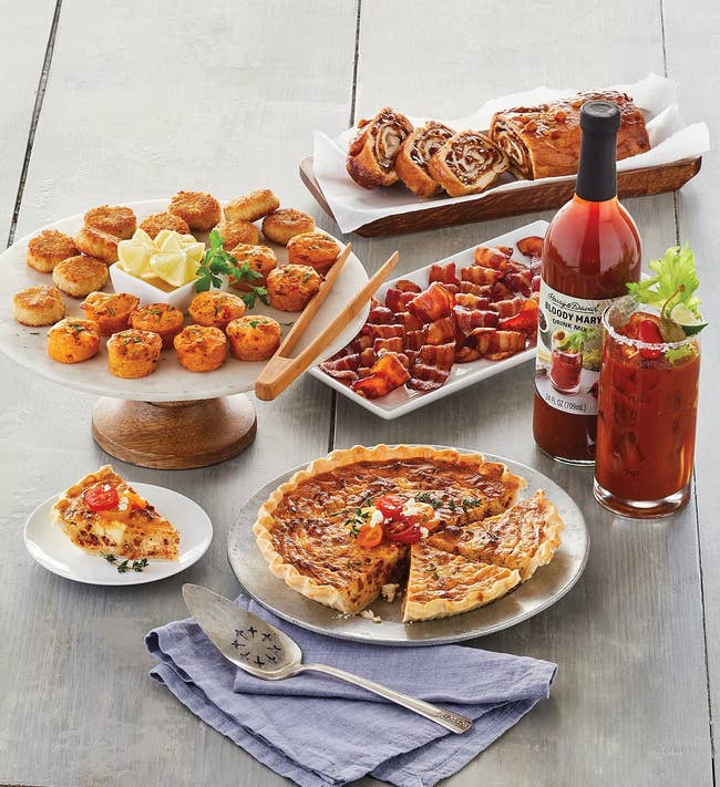 Assorted brunch items with quiche, Bloody Mary, and pastries included in the gift set