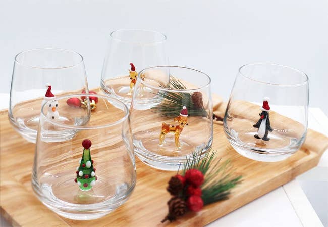glasses with a snowman, tree, deer, and penguin