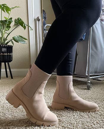 side view of reviewer wearing the beige boots