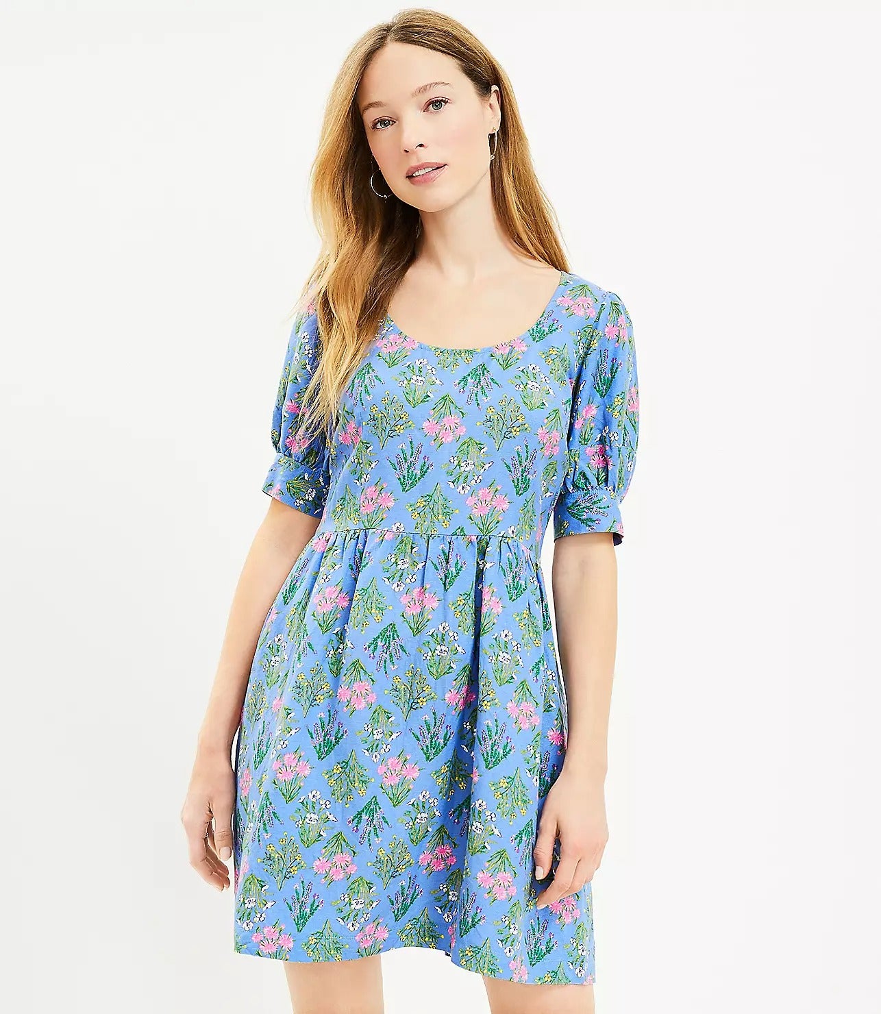 model in blue short sleeve dress with pink green yellow and white floral print
