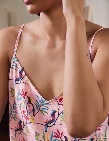 closeup of model wearing the pink set with birds on it